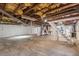 This basement features exposed pipes and stairs leading to an upper level, offering potential for customization at 7415 Old Oxford Rd, Bahama, NC 27503