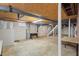 This unfinished basement offers ample space with exposed ceiling and potential for customization at 7415 Old Oxford Rd, Bahama, NC 27503