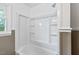 This bathroom has a shower and tub combo with bright white walls, offering a clean, modern look at 7415 Old Oxford Rd, Bahama, NC 27503