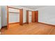 This bedroom features hardwood floors and multiple closets with wood trim, offering plenty of storage at 7415 Old Oxford Rd, Bahama, NC 27503