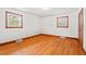 This bedroom boasts hardwood floors and bright natural light from two windows for a warm, inviting space at 7415 Old Oxford Rd, Bahama, NC 27503