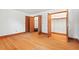 This bedroom features hardwood floors and multiple closets with wood trim, providing ample storage at 7415 Old Oxford Rd, Bahama, NC 27503
