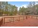 This spacious deck has wooden railings that offer beautiful views of the wooded lot and natural surroundings at 7415 Old Oxford Rd, Bahama, NC 27503