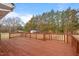 The spacious wooden deck is surrounded by lush trees, offering an ideal outdoor spot for relaxation and entertainment at 7415 Old Oxford Rd, Bahama, NC 27503