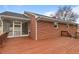The exterior view showcases a brick house with a wooden deck and screened-in porch, offering a charming and inviting appeal at 7415 Old Oxford Rd, Bahama, NC 27503