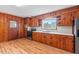 Well-lit kitchen with ample wood cabinets, countertops, and room for dining at 7415 Old Oxford Rd, Bahama, NC 27503