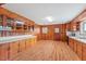 Spacious kitchen with ample wood cabinets, countertops, and access to the backyard at 7415 Old Oxford Rd, Bahama, NC 27503