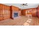 Inviting living room featuring a cozy fireplace, built-in shelving, and paneled walls at 7415 Old Oxford Rd, Bahama, NC 27503
