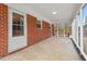 The sunroom features brick walls, screened windows, and an open design that connects with the outdoors at 7415 Old Oxford Rd, Bahama, NC 27503