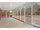 The sunroom's screened windows offer views of the surrounding landscape and access to the outdoor deck at 7415 Old Oxford Rd, Bahama, NC 27503