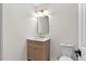 Bathroom features a vanity with marble countertops and gold accents, and an illuminated vanity mirror at 7725 Longstreet Dr, Raleigh, NC 27615