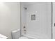 Updated bathroom features white subway tile, a gold rainfall shower head, and a built-in soap dish at 7725 Longstreet Dr, Raleigh, NC 27615