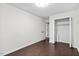 Bedroom with neutral paint and wood floors and closet for storage at 7725 Longstreet Dr, Raleigh, NC 27615