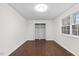 Bedroom with dark wood flooring, a window, a closet and white painted walls at 7725 Longstreet Dr, Raleigh, NC 27615