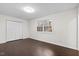 Bright bedroom featuring wood floors, a window with natural light, and a closet with white doors at 7725 Longstreet Dr, Raleigh, NC 27615
