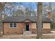 Charming brick home featuring a well-manicured lawn, inviting entrance, and an idyllic suburban setting at 7725 Longstreet Dr, Raleigh, NC 27615