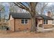 Charming brick home with a cozy front porch and a mature shade tree at 7725 Longstreet Dr, Raleigh, NC 27615