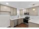 Well-appointed kitchen featuring stainless steel appliances, quartz countertops, and modern cabinetry at 7725 Longstreet Dr, Raleigh, NC 27615