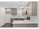 Updated kitchen features stainless steel appliances, a white tile backsplash, and gray cabinets and countertops at 7725 Longstreet Dr, Raleigh, NC 27615