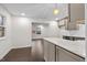Open-concept kitchen with a marble island and gray cabinets; the island overlooks the living and dining rooms at 7725 Longstreet Dr, Raleigh, NC 27615
