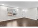 Bright and airy living room featuring hardwood floors, a large window, and fresh, neutral paint at 7725 Longstreet Dr, Raleigh, NC 27615