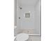 Modern shower with white subway tiles, rainfall showerhead, and hexagon tile flooring at 7725 Longstreet Dr, Raleigh, NC 27615