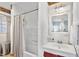 Clean bathroom with a shower-tub combo, tiled walls, and a vanity with a mirror at 805 S 11Th St, Lillington, NC 27546