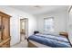Bedroom with a bed, side table, wooden wardrobe, and a view to the next room at 805 S 11Th St, Lillington, NC 27546