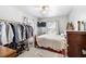 Comfortable bedroom with a built in closet rack and a view from the window at 805 S 11Th St, Lillington, NC 27546