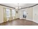 Sunlit dining room showcasing hardwood floors, modern chandelier, and entry to the adjacent room at 805 S 11Th St, Lillington, NC 27546