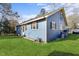 Quaint blue house with green grass, a satellite dish, and mature trees in a suburban neighborhood at 805 S 11Th St, Lillington, NC 27546