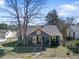 Charming blue home with a yellow trim, a cozy porch and a metal fence in the front yard at 805 S 11Th St, Lillington, NC 27546