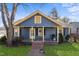 Charming home featuring a covered front porch, mature tree, and a well-maintained lawn at 805 S 11Th St, Lillington, NC 27546