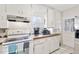 Bright kitchen featuring tile countertops, a stainless steel microwave, and ample storage at 805 S 11Th St, Lillington, NC 27546