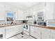 Functional kitchen with white cabinets, tile countertops, and a vintage-style stove at 805 S 11Th St, Lillington, NC 27546