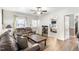 Comfortable living room with hardwood floors, a ceiling fan, and view into the bedroom at 805 S 11Th St, Lillington, NC 27546