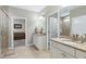 Bright bathroom featuring double vanity with granite countertops, tile floor, and a glass door shower at 823 Atticus Way, Durham, NC 27703