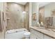 A bathroom with a sink and a bathtub shower combination featuring beige tiles on the walls at 823 Atticus Way, Durham, NC 27703