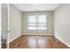 A neutral bedroom offers hardwood floors and natural light at 823 Atticus Way, Durham, NC 27703