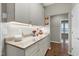 Bright butlers pantry boasts ample counter space, wooden floors, and custom white cabinets with modern hardware at 823 Atticus Way, Durham, NC 27703