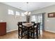 Dining room with hardwood floors and lots of natural light through a series of windows at 823 Atticus Way, Durham, NC 27703