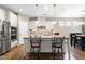 Bright kitchen with white cabinets, stainless appliances, an island and hardwood floors at 823 Atticus Way, Durham, NC 27703