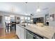 Kitchen island with counter seating, stainless steel dishwasher, and an open floor plan at 823 Atticus Way, Durham, NC 27703