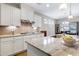 A modern kitchen features stainless appliances, light countertops, and a gas cooktop at 823 Atticus Way, Durham, NC 27703