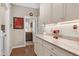 A kitchen with wooden flooring, white cabinets, granite countertops, and stainless steel appliances at 823 Atticus Way, Durham, NC 27703