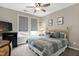 This well-lit main bedroom features two windows, a bed with a metal frame, and carpeted floors at 823 Atticus Way, Durham, NC 27703