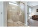 The tiled glass shower features a shower head and a built-in tiled seat, as well as a small window for natural light at 823 Atticus Way, Durham, NC 27703