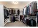 The walk-in closet features shelves all around as well as hanging racks and carpeted flooring at 823 Atticus Way, Durham, NC 27703