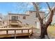 Back exterior showcasing a spacious deck, patio area, and mature trees at 8341 Wynewood Ct, Raleigh, NC 27616