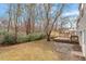 Spacious backyard with a wooden deck, mature trees, and lush greenery at 8341 Wynewood Ct, Raleigh, NC 27616